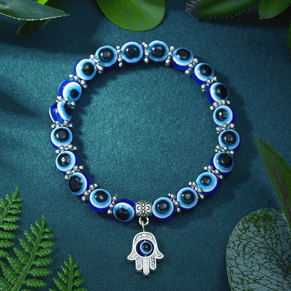 Close-up of a vibrant blue Evil Eye charm on a stylish Unisex protection anklet, symbolic jewelry.