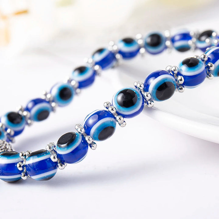 Stylish Unisex Evil Eye protection anklet with intricate charm detail, bohemian symbolic jewelry.