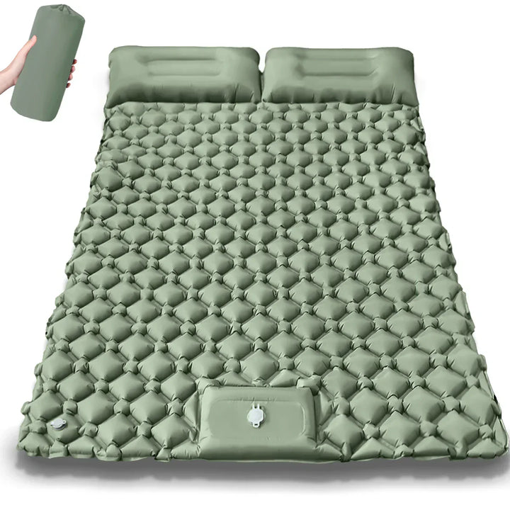 Unisex Kieran model extra-wide double inflatable camping mattress next to campfire