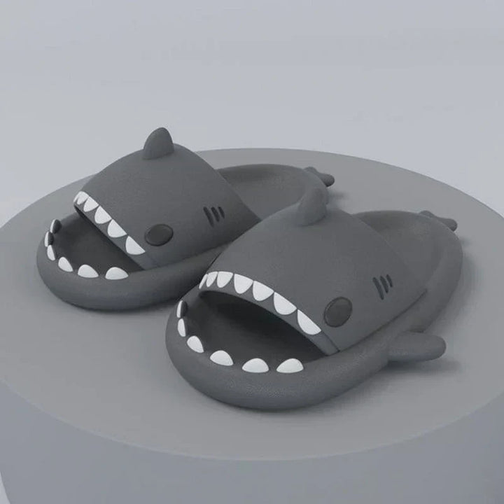 Close-up of FinSteps shark design flip flops, showing detailed fin strap & comfortable sole for beachwear.