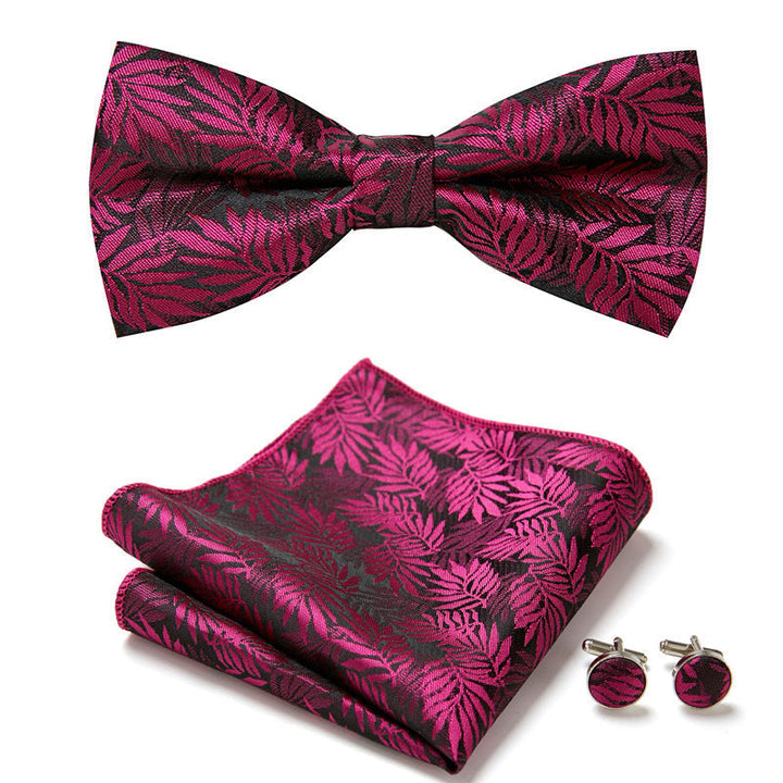Unisex floral bow tie set with intricate design, includes matching pocket square and cufflinks for formal wear.