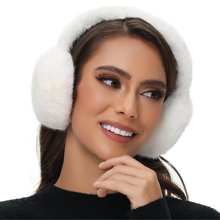 Person hiking wearing brown faux fur ear warmers, keeping warm outdoors