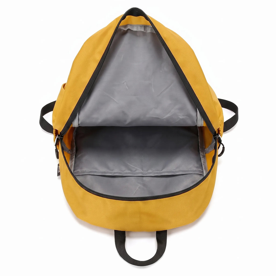 Man wearing a lightweight unisex hiking backpack on a trail, perfect for day hikes.
