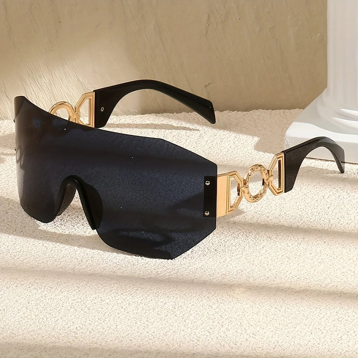 Modern futuristic unisex sunglasses, gradient lenses, and gold temples. Stylish shades with UV400 protection.