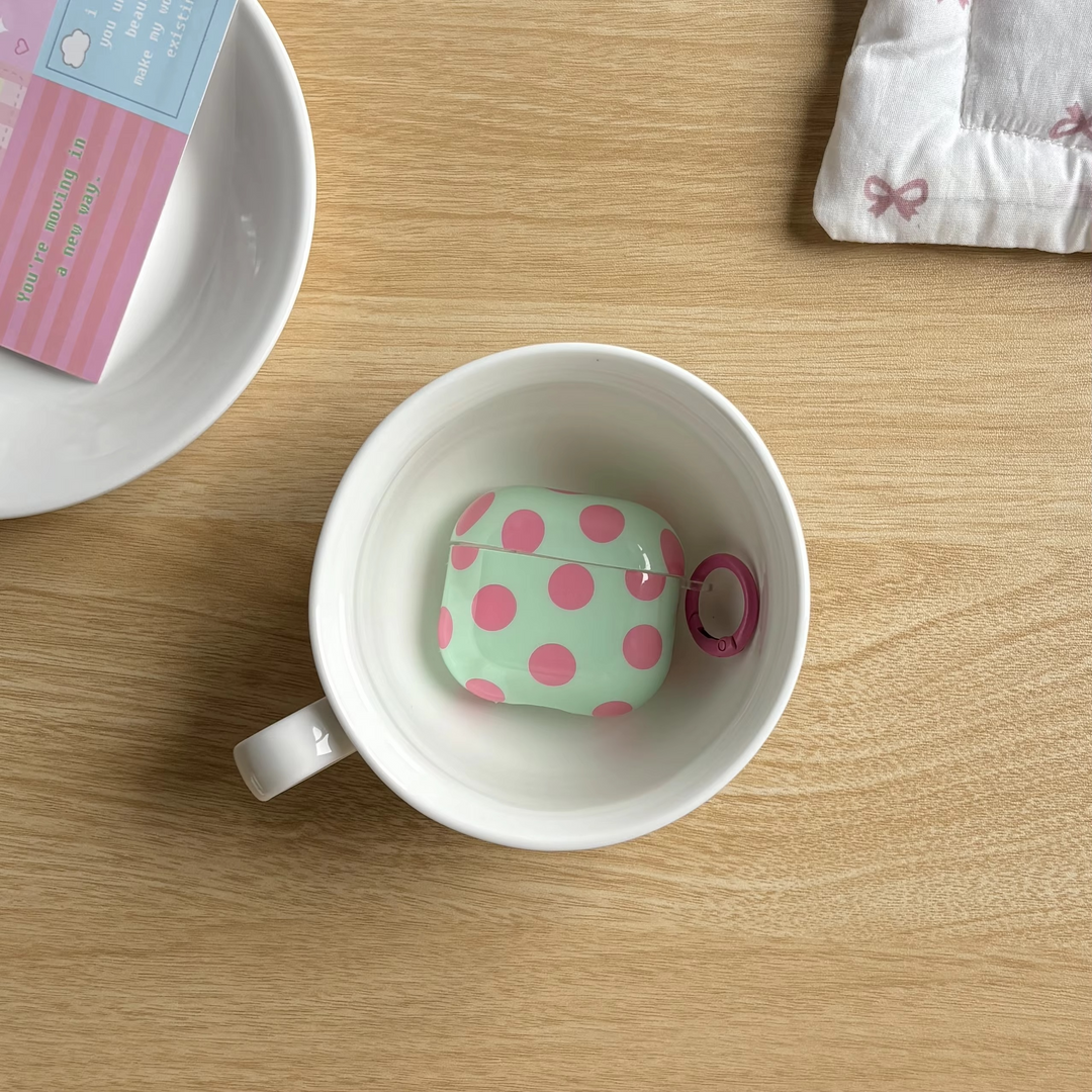 Protective glossy polka dot earphone case with ring for AirPods. Portable & chic unisex earbuds cover.