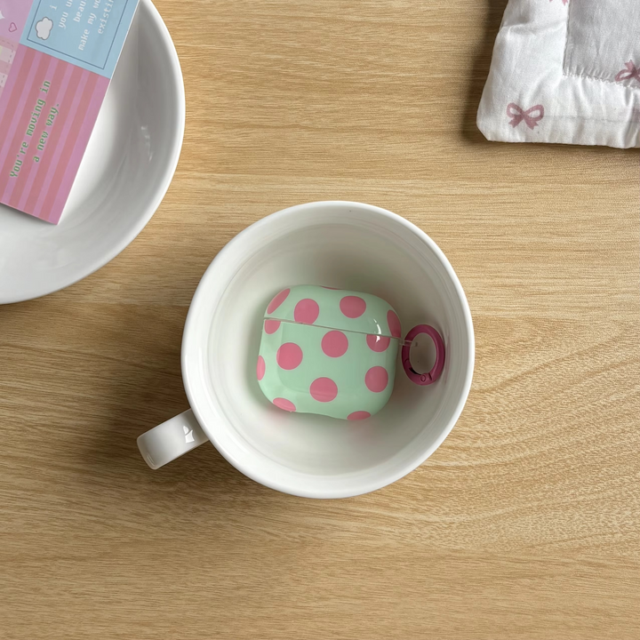 Protective glossy polka dot earphone case with ring for AirPods. Portable & chic unisex earbuds cover.