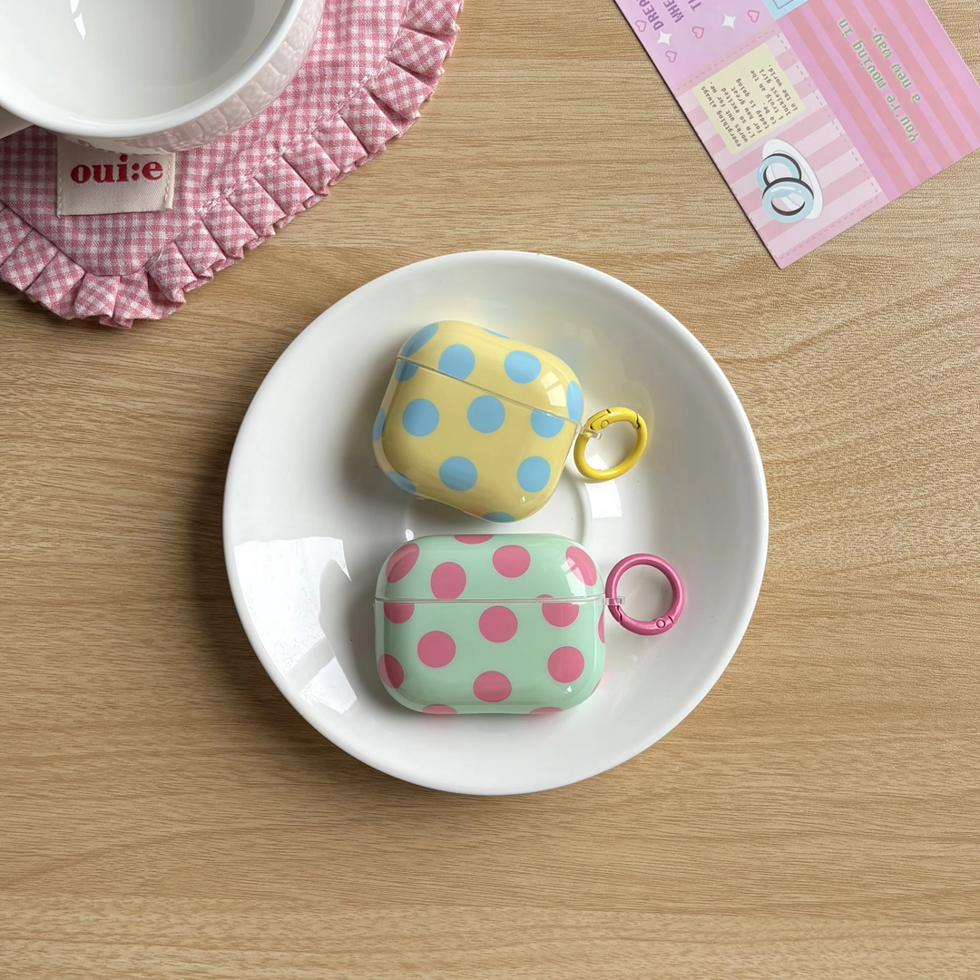 Stylish glossy polka dot AirPods case. Unisex protective earphone cover with a handy ring for wireless earbuds.
