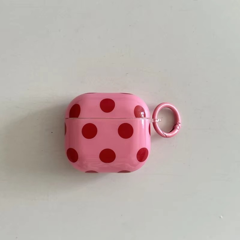 Wireless earbuds accessory: glossy polka dot AirPods case with ring. Protective, portable, & stylish unisex.