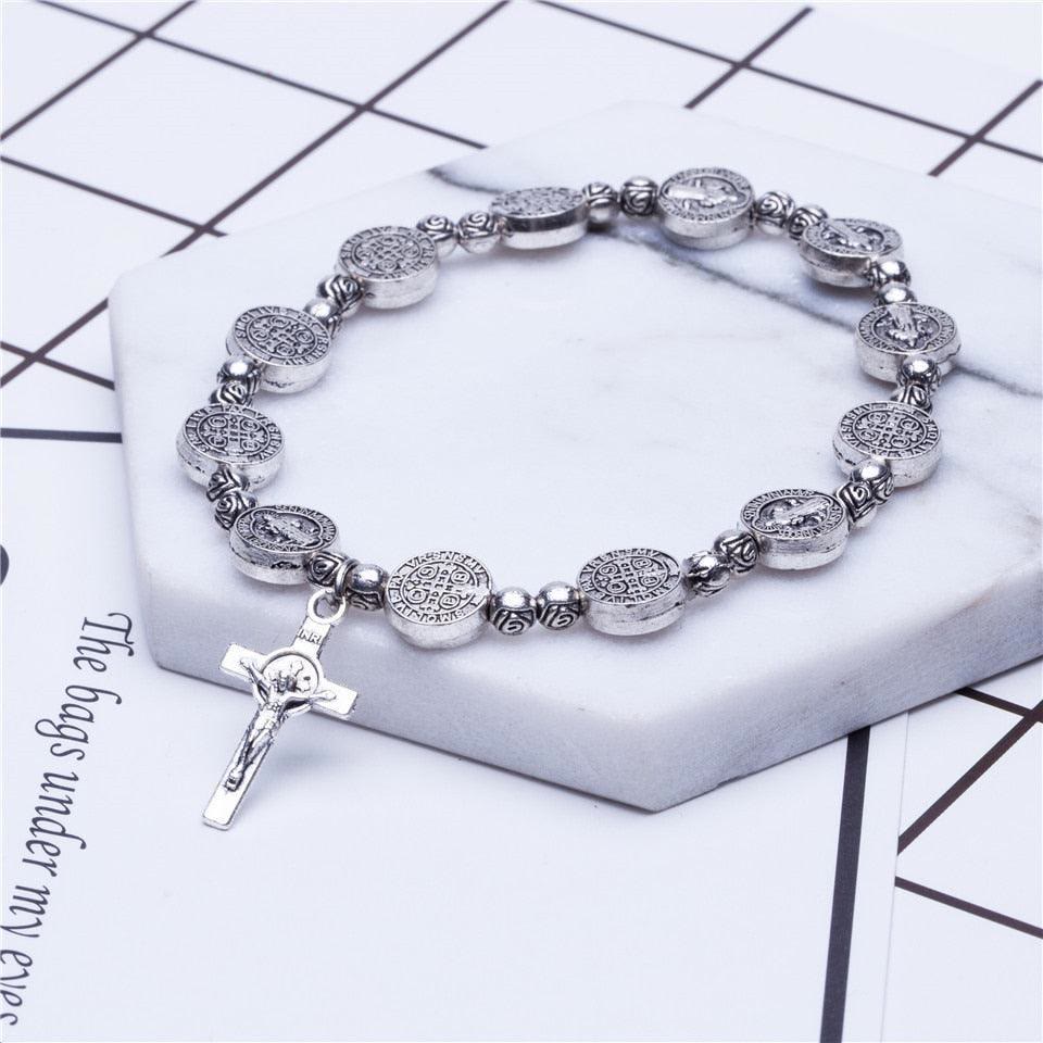 Religious Christian cross bracelet in gold & silver, a fashionable unisex jewelry item and faith symbol.