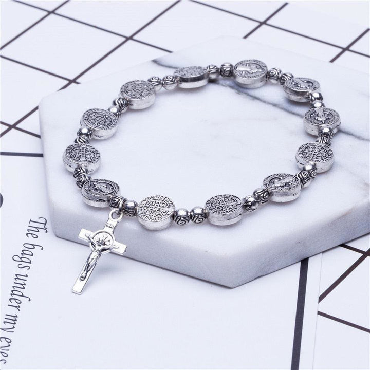 Religious Christian cross bracelet in gold & silver, a fashionable unisex jewelry item and faith symbol.