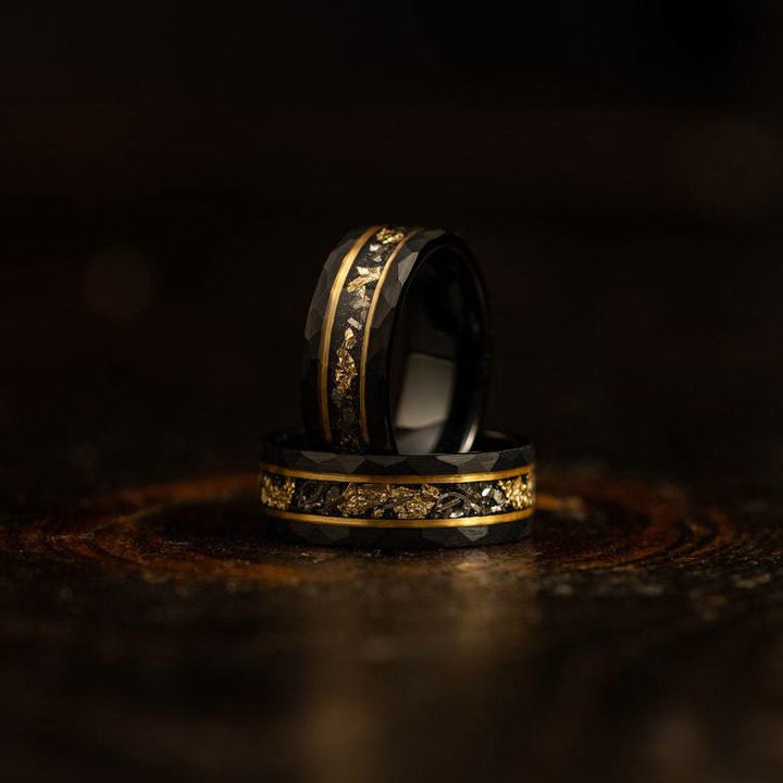 Stunning black tungsten ring with glittering meteorite dust and elegant golden leaf accent.