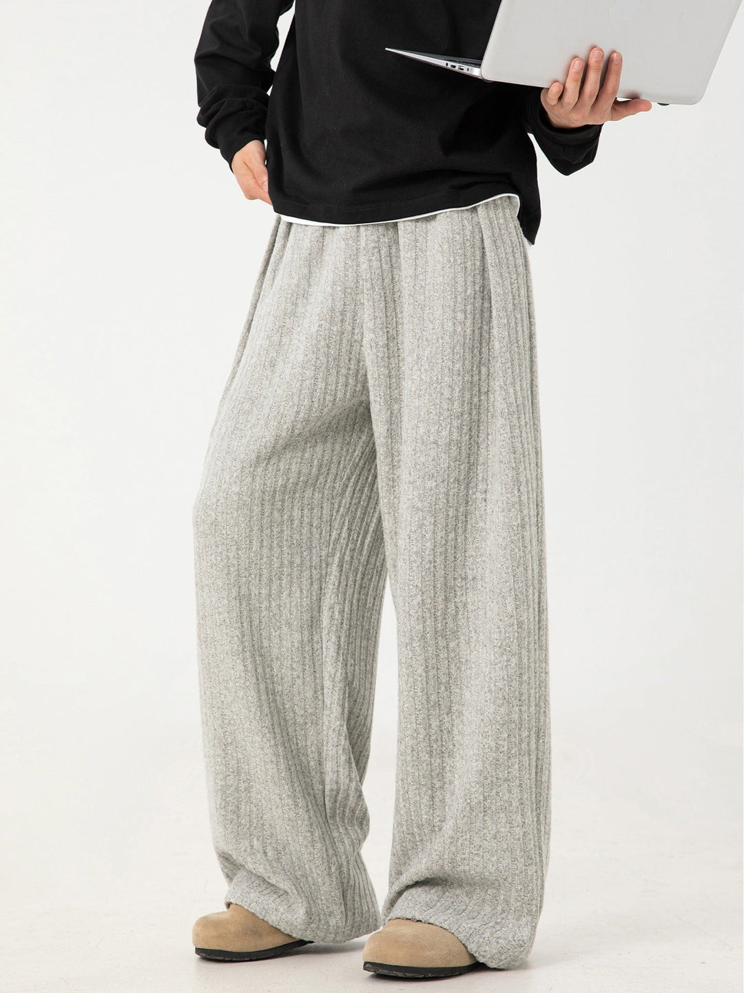 Model wearing gray unisex cloud-soft comfort lounge pants, showcasing 4-way stretch and relaxed fit.