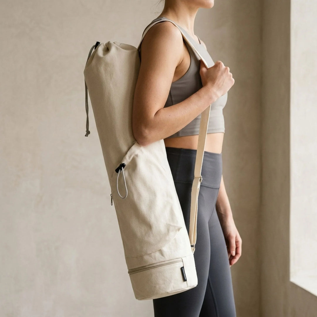 Unisex hands-free yoga mat carrier bag with pockets, perfect for gym or yoga studio.