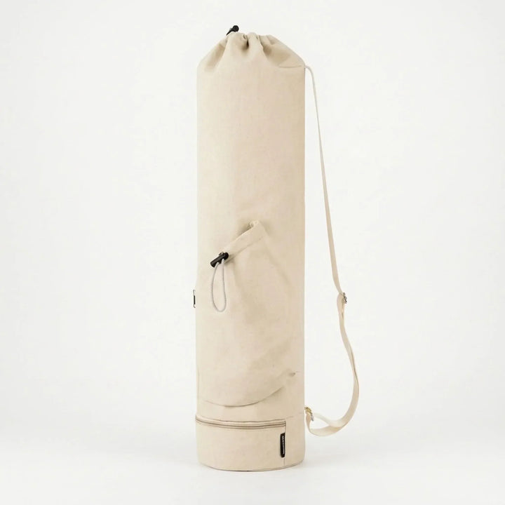 Durable nylon hands-free yoga mat carrier with multiple pockets for fitness accessories.