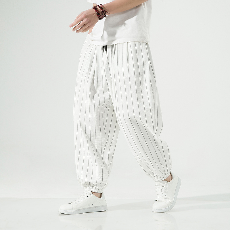 Comfortable pinstripe harem jogger pants for unisex wear. Stylish linen blend with a relaxed drawstring fit.