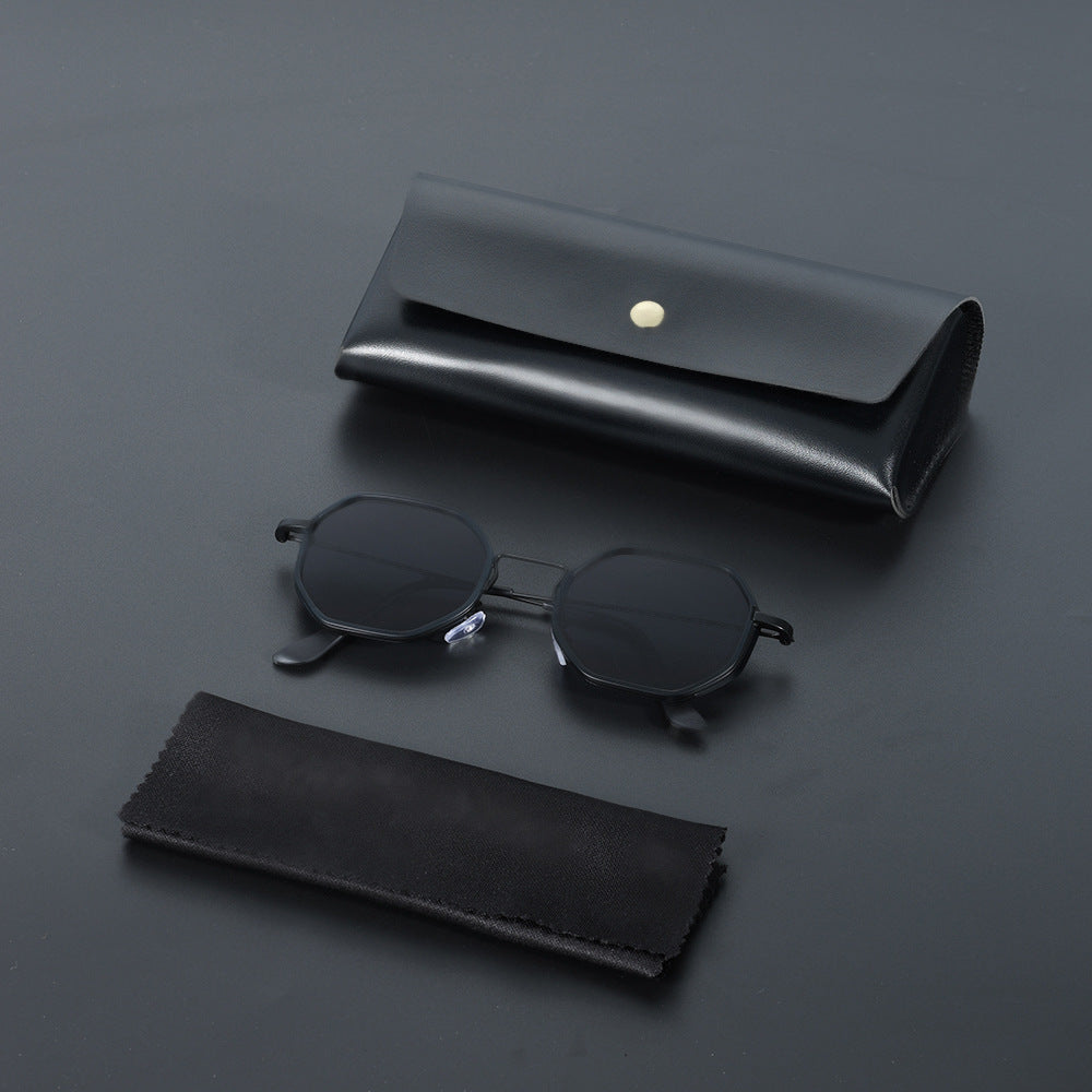 Classic unisex hexagonal sunglasses with black UV400 lenses, lightweight and modern eyewear.
