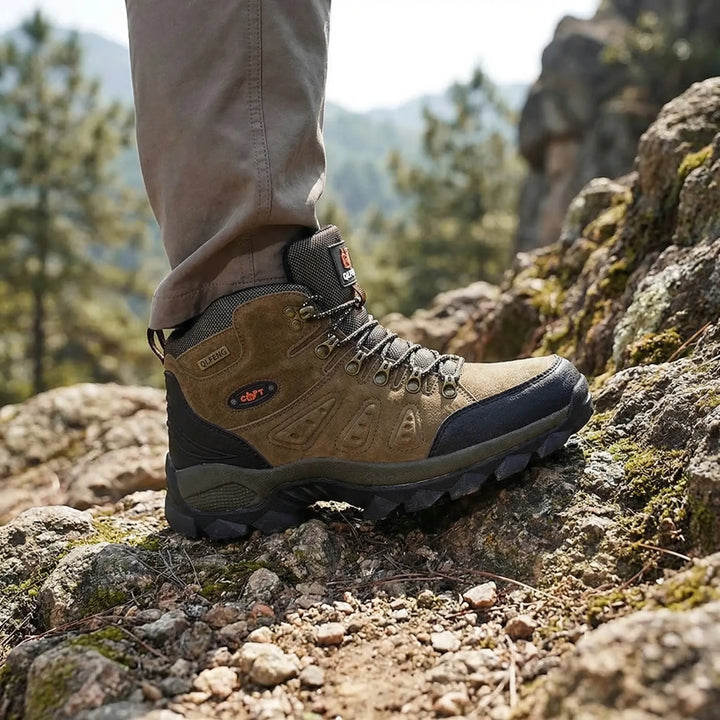 Unisex high-top hiking boots with rugged outsole for superior trail grip & ankle support. Durable outdoor footwear.