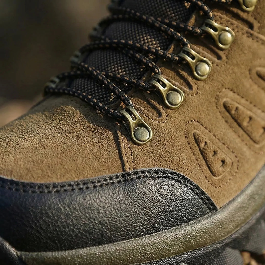 Gray unisex high-top hiking boots with a rugged outsole, providing excellent trail grip & ankle support for adventure.