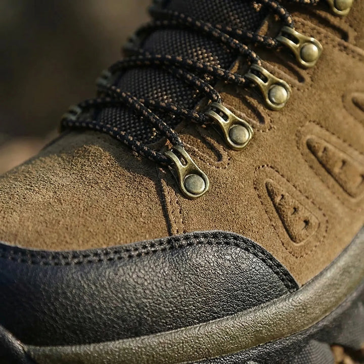 Gray unisex high-top hiking boots with a rugged outsole, providing excellent trail grip & ankle support for adventure.