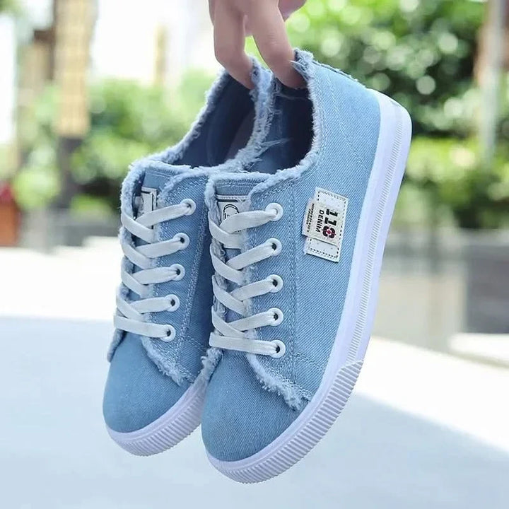 Fashionable white high-top sneakers with laces, offering unisex appeal and ultimate everyday comfort.
