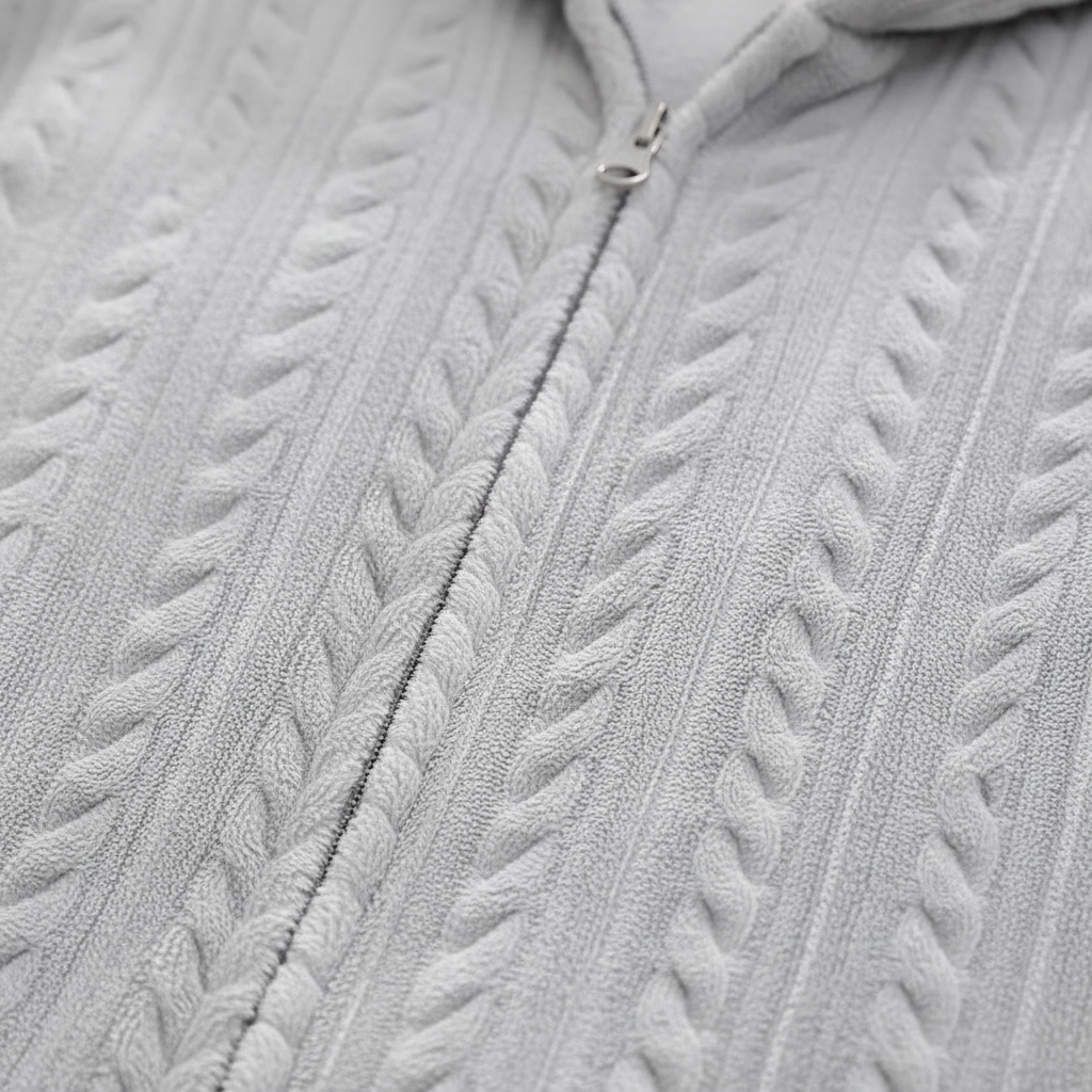 Close-up of the zipper on a soft flannel unisex hooded bathrobe, emphasizing quality