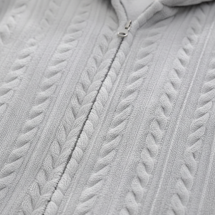 Close-up of the zipper on a soft flannel unisex hooded bathrobe, emphasizing quality