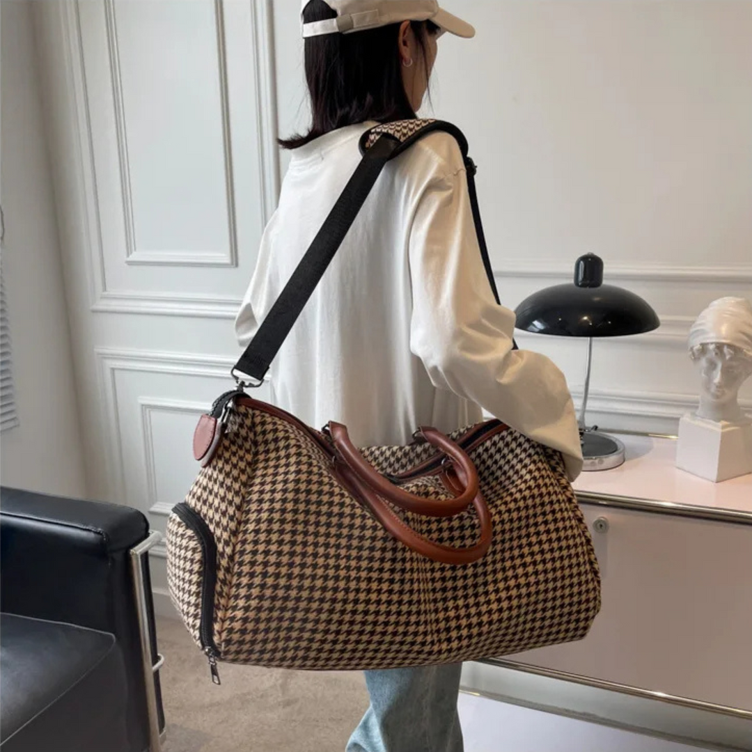 Elegant houndstooth pattern on a unisex weekender travel bag. Durable vegan leather carry-on luggage for stylish travel.