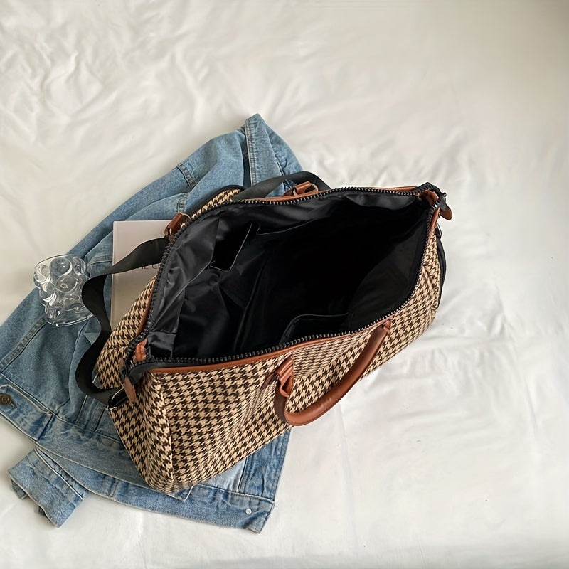 Close-up of durable vegan leather and houndstooth fabric on a unisex weekender travel bag. Quality carry-on luggage.