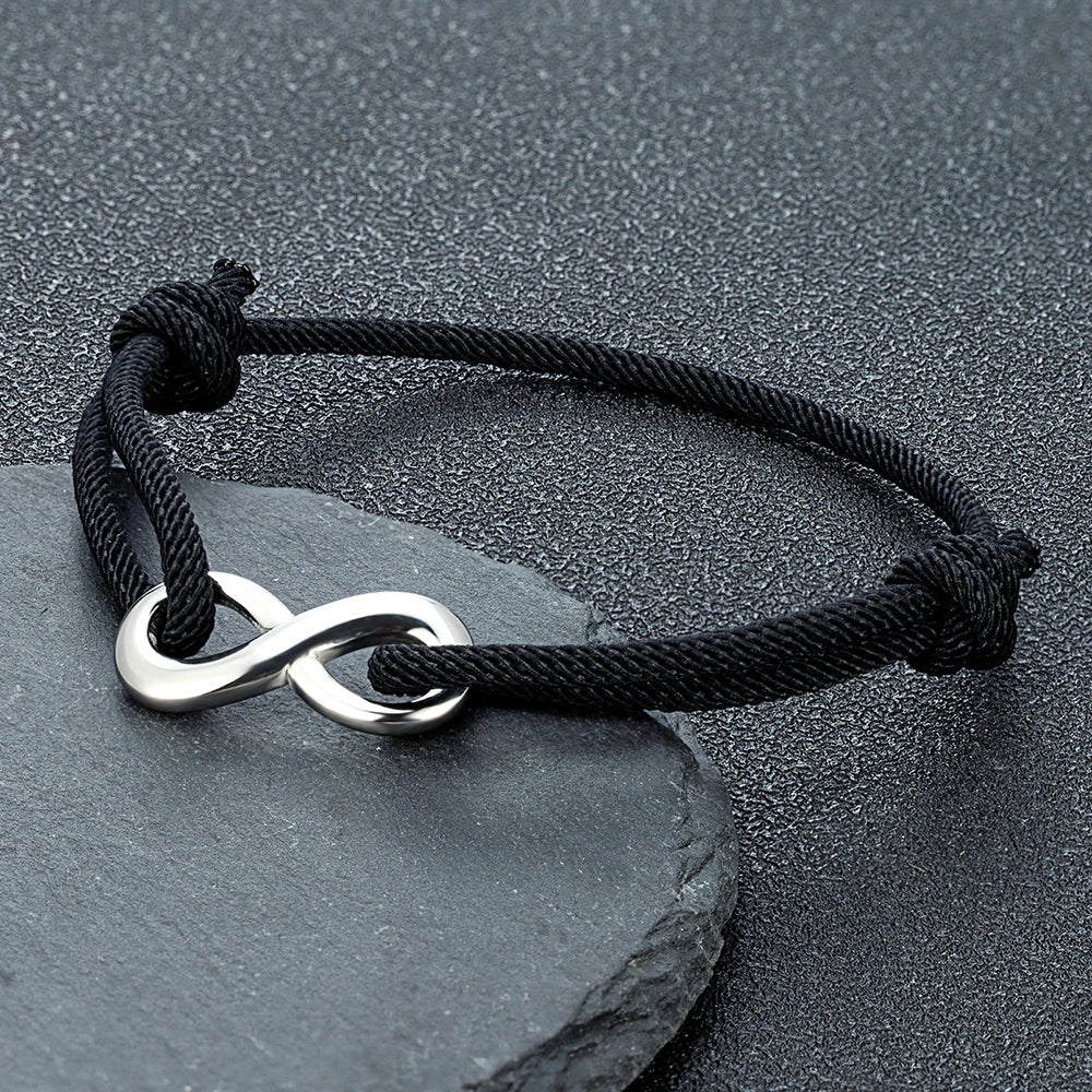 Stainless steel infinity cord bracelet; adjustable, modern unisex accessory for everyday wear.