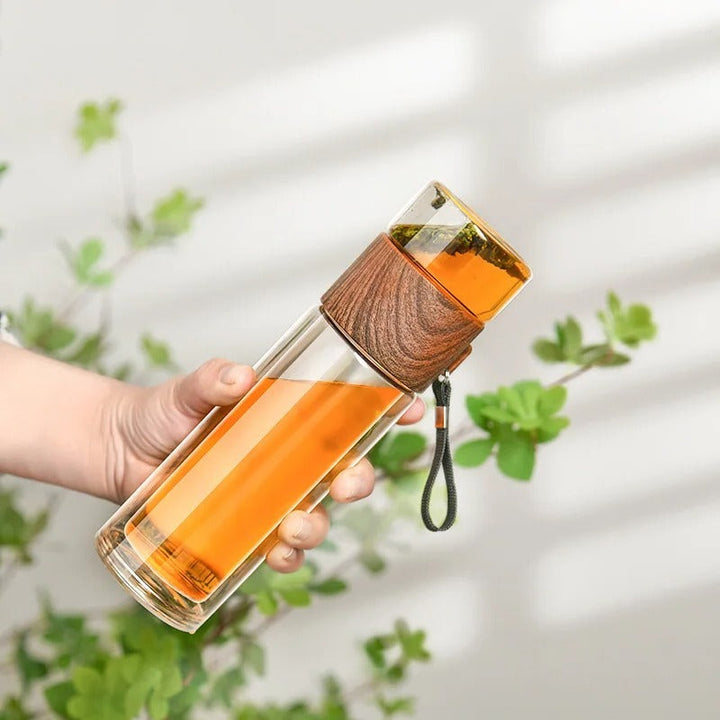 Unisex insulated glass water bottle with tea infuser for hot & cold drinks. Reusable & portable travel mug.