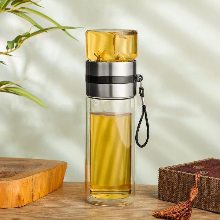 Enjoy your favorite hot tea or cold brew on the go with this portable insulated glass water bottle & infuser.