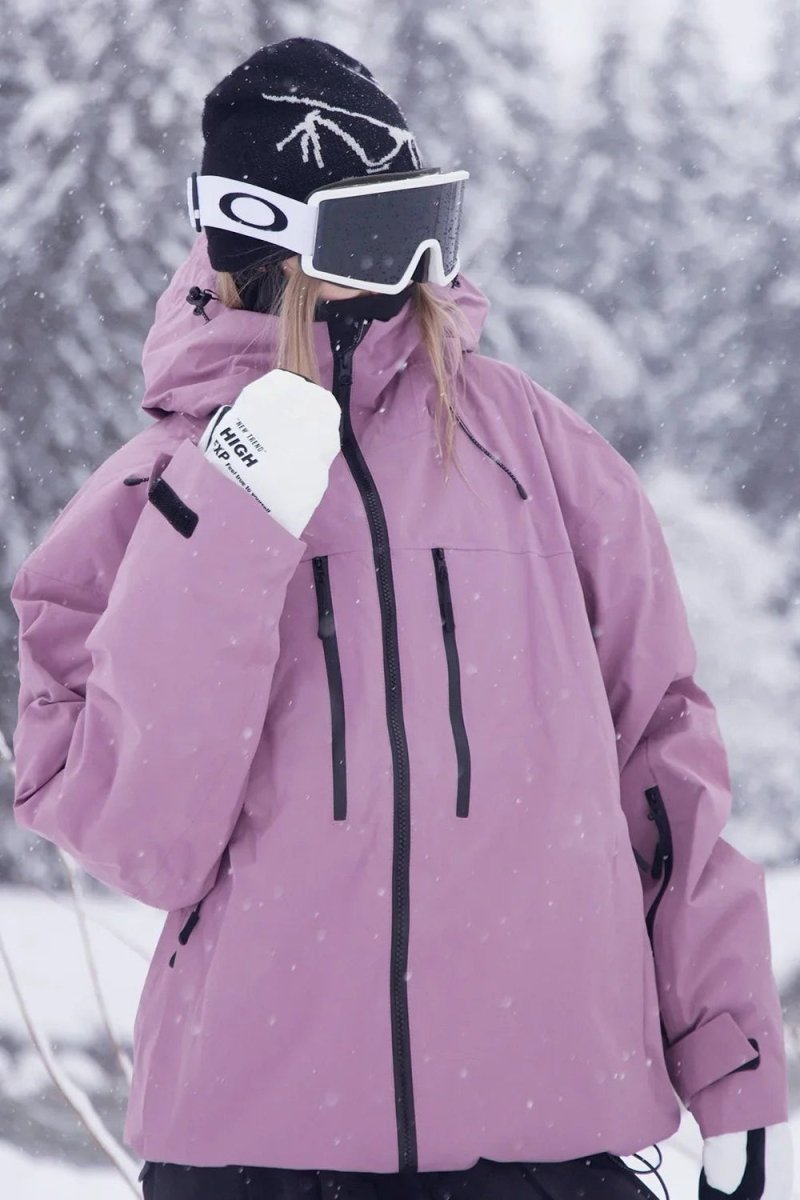 Heavy-duty zippers and fastenings on unisex weather-resistant ski & snowboard jacket. Secure outdoor wear.