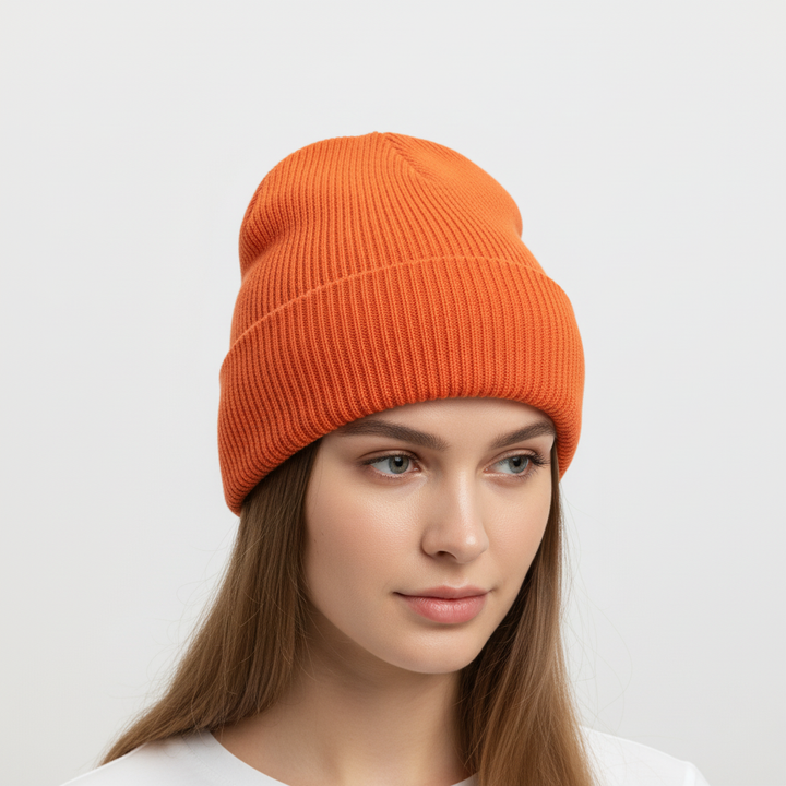 Flat lay of a red one-size knitted beanie, warm and comfortable winter accessory