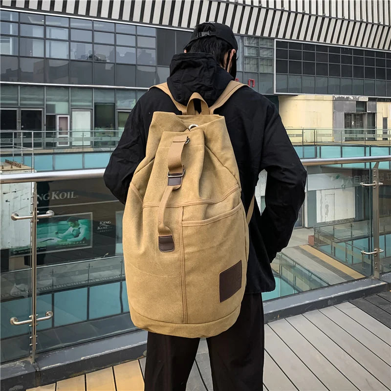 Front view of black canvas travel rucksack, perfect for hiking and as a daily duffel bag.