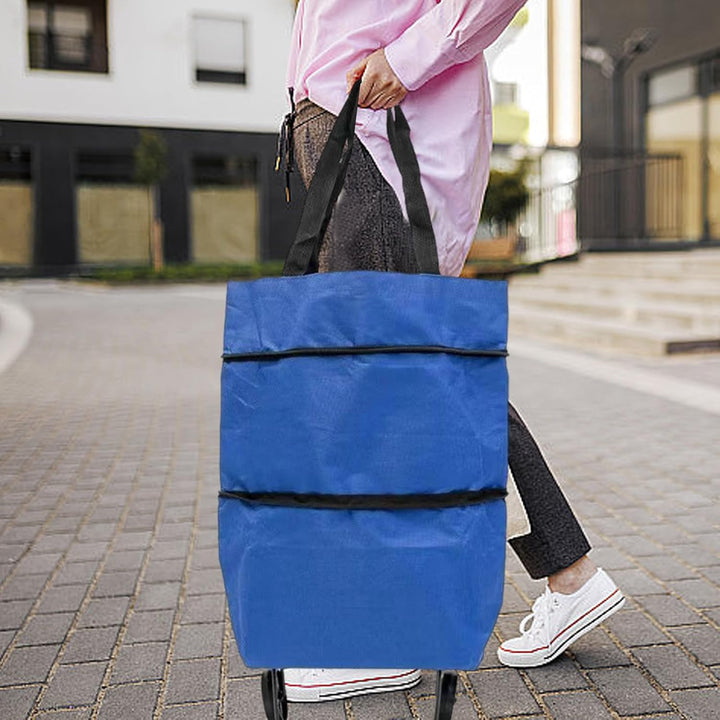 Reusable shopping tote with wheels, black, flat-packed showing its ultra-compact foldable design