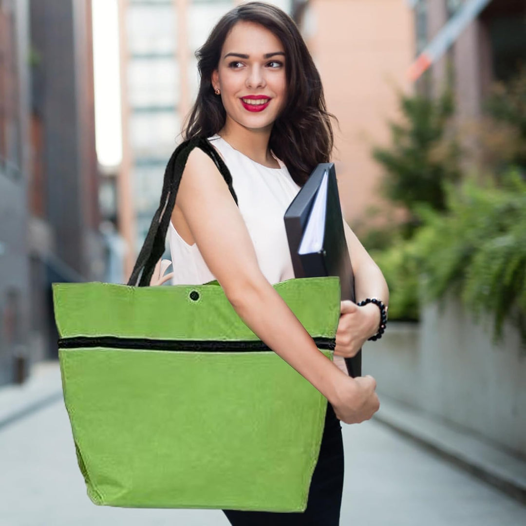 Unisex large capacity foldable wheeled bag, black, in a folded state next to a standard tote bag