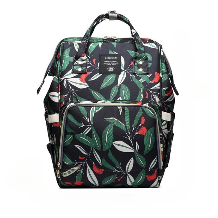 Unisex travel diaper bag worn by a parent, showing side pockets & capacity