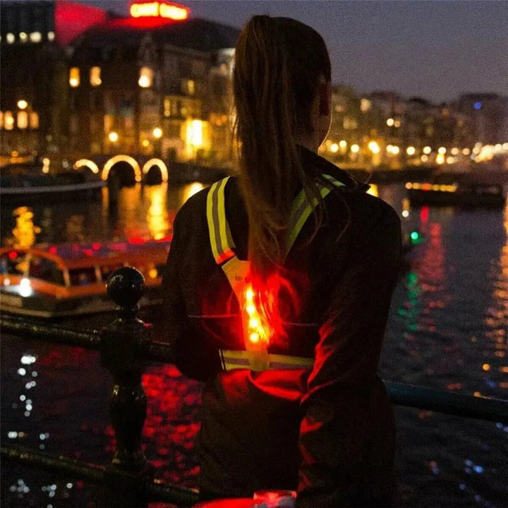 Pink LED reflective running vest, adjustable for women's high visibility safety.