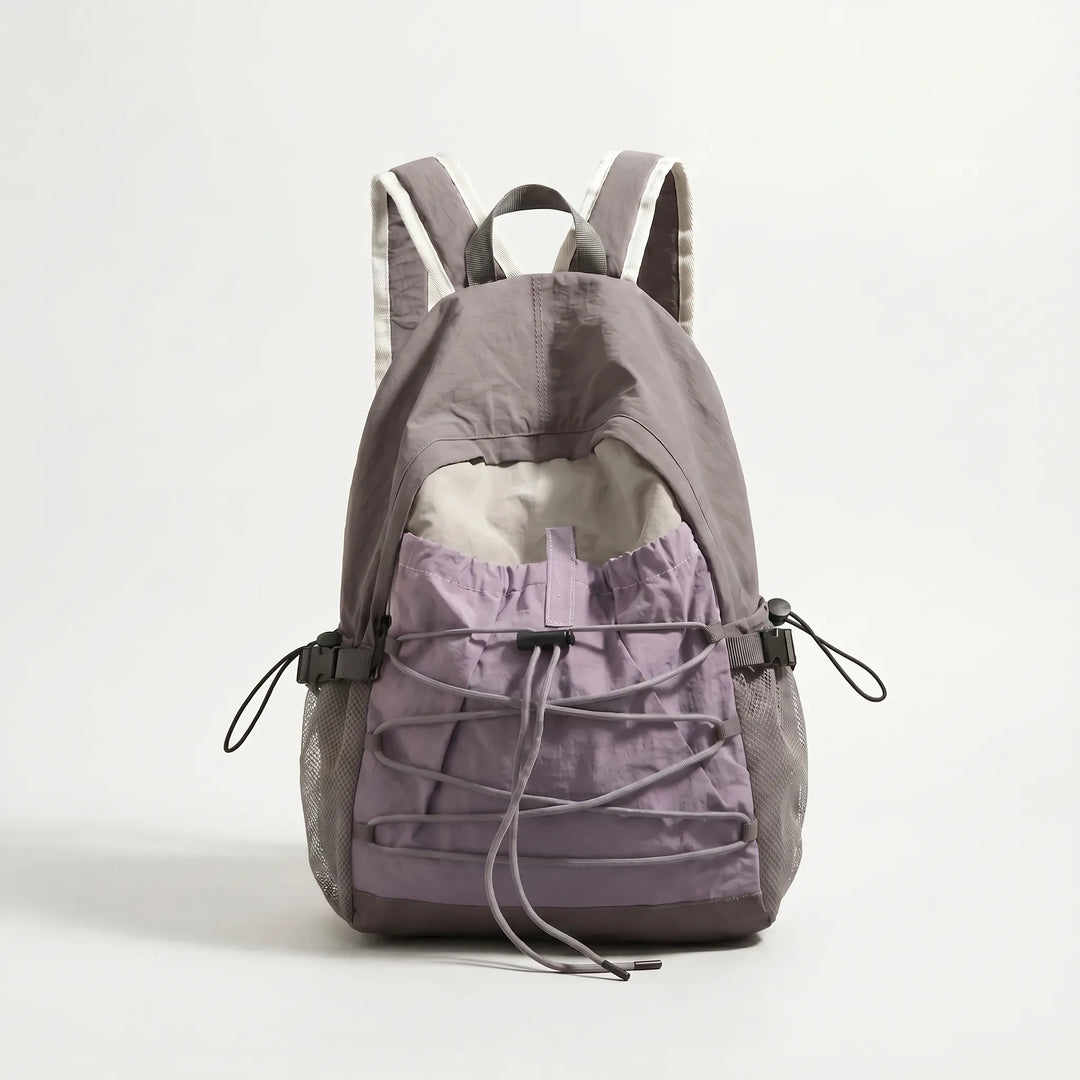 Front view of a sleek, lightweight outdoor travel backpack with multiple compartments for hiking essentials.