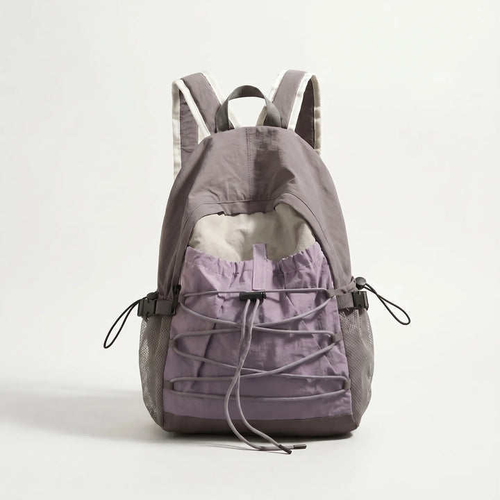 Front view of a sleek, lightweight outdoor travel backpack with multiple compartments for hiking essentials.