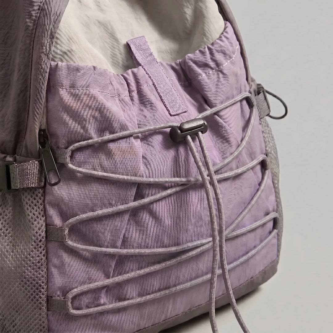 Side profile of a compact, unisex lightweight backpack, designed for easy packing and versatile travel.