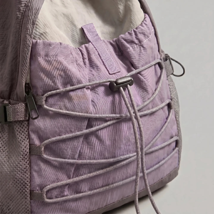 Side profile of a compact, unisex lightweight backpack, designed for easy packing and versatile travel.