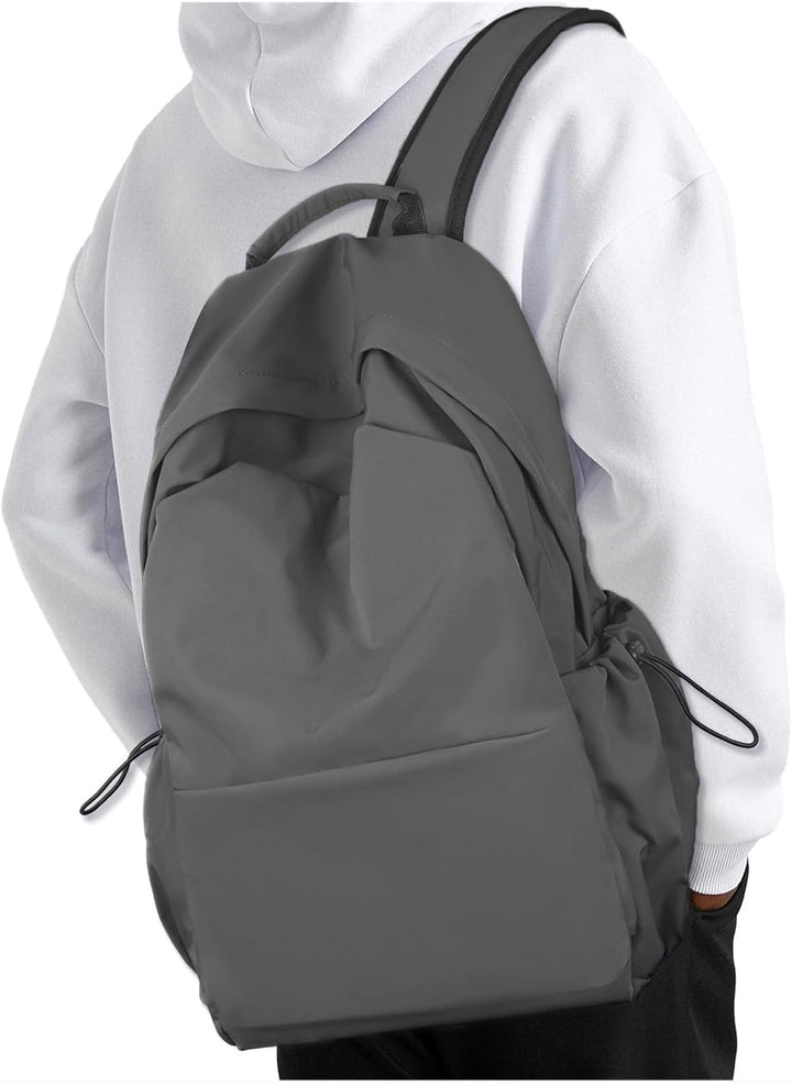 Side pocket of navy blue water-resistant backpack holding a water bottle securely