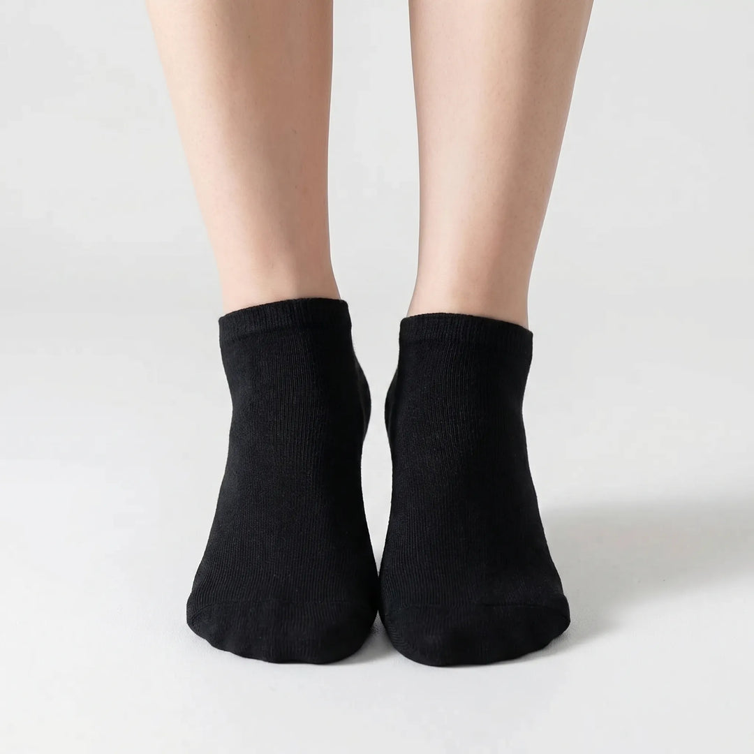 Close-up of a white low-cut ankle sock, showcasing its soft fabric and snug, comfortable fit for all.