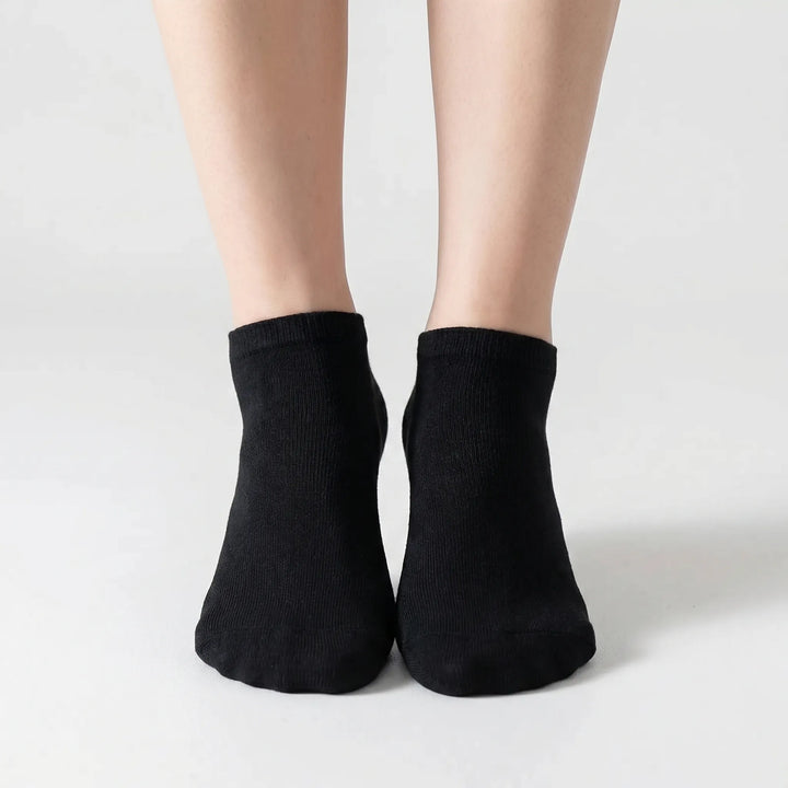 Close-up of a white low-cut ankle sock, showcasing its soft fabric and snug, comfortable fit for all.