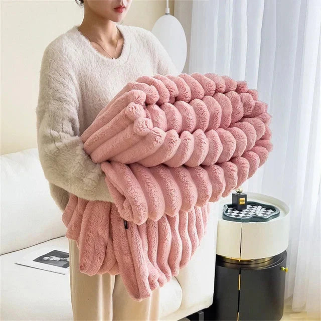 Unisex comfy plush throw blanket on a bed, suggesting warmth and cozy sleep
