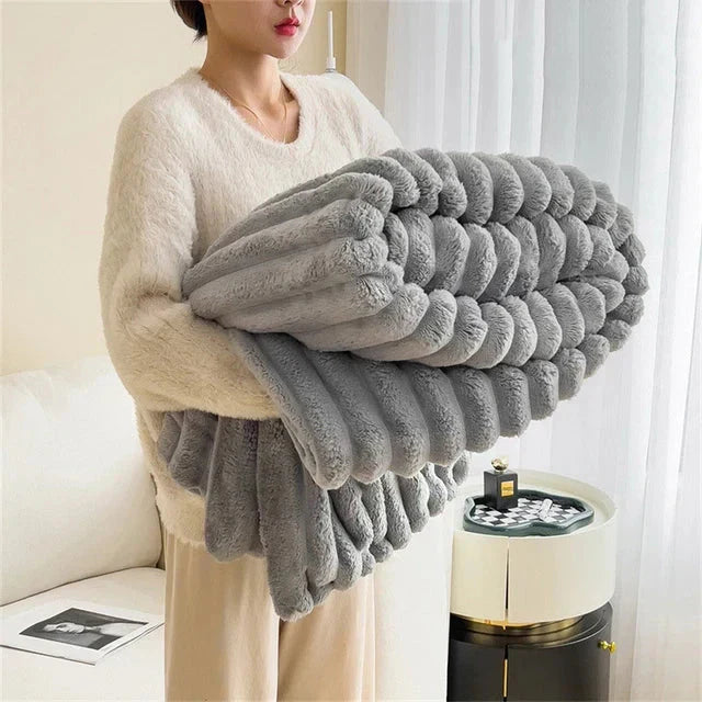 Folded luxury plush comfort throw blanket, showcasing its softness and elegant design
