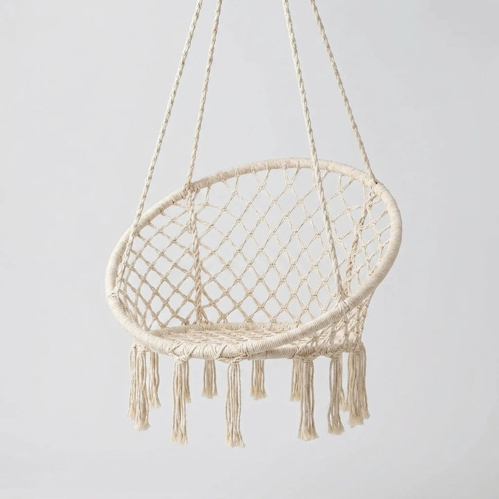 Outdoor macrame hammock chair swing on a patio, ideal for garden relaxation.