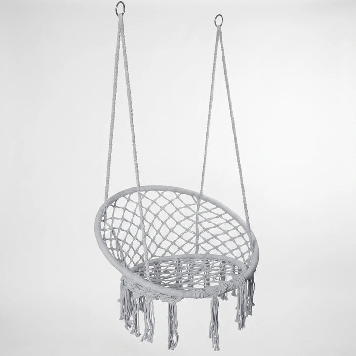 Comfortable white macrame hammock chair swing, ideal for relaxing in any setting.