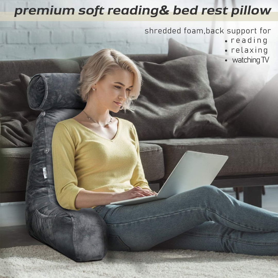 Soft memory foam reading pillow with integrated arm support, designed for extended comfortable reading.